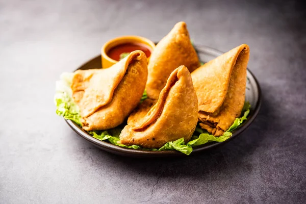 stock image samosa or singara. Indian fried or baked pastry with a savory filling, spiced potatoes, onion, peas