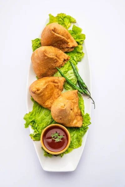 stock image samosa or singara. Indian fried or baked pastry with a savory filling, spiced potatoes, onion, peas