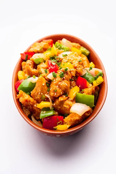 stock image Chilli chicken which is a popular Indo-Chinese starter dish, served on a plate or bowl. Selective focus