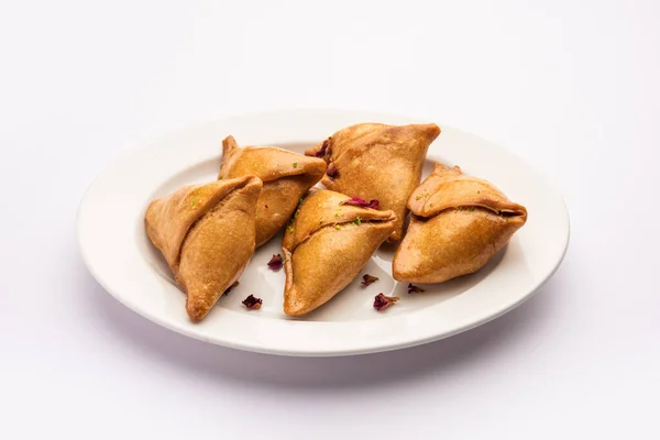 Vegetarian Aloo samosa or samosas. Indian special traditional street food.  Famous Indian Punjabi samosa filled with spicy boiled potato mixture.  served with green and red chutneys. Copy space. Stock Photo