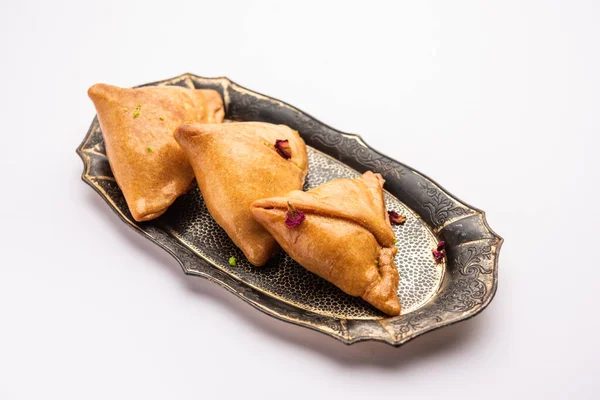 stock image Indian sweet samosa is a Fried pastry soaked in sugar syrup filled with coconut, nuts and fruits