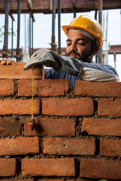 stock image Happy Indian male construction worker constructing brick wall - hard working concept, manual labour