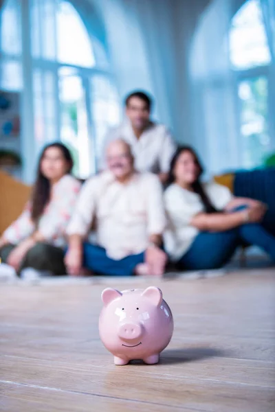 financial planning, Indian family mother father and children with piggy Bank at home