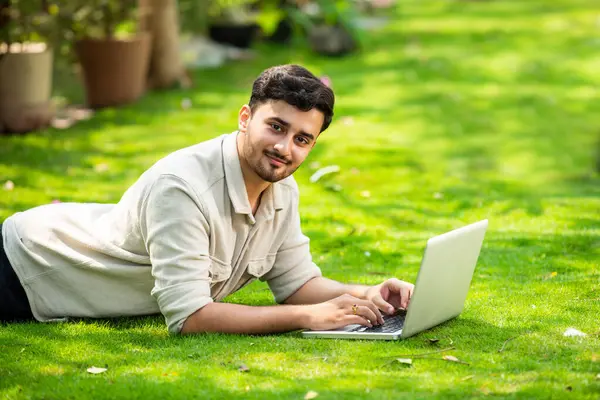 Young Handsome Indian Asian Man Using Laptop Park While Lying — Stock Photo, Image