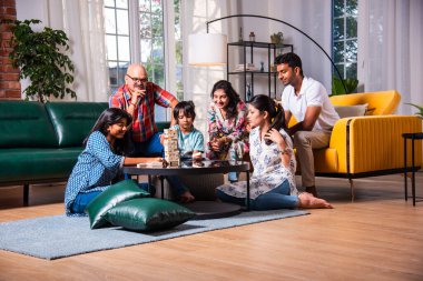 Hindistan 'ın Asyalı çok nesilli ailesi, tahta bloklama oyununu birlikte oynayıp eğleniyor.