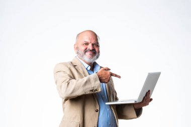 Hintli yaşlı emekli iş kıyafetleri içinde emekli bir adam ya da dizüstü bilgisayarı beyazlara karşı kullanıyor.