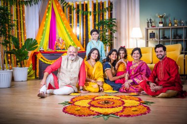 Indian family united in making Diwali flower Rangoli, ganesh festival celebrating bonds, traditions