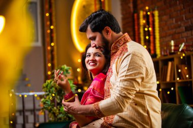 Eşine Altın Bilezik Veren Koca, Evde Diwali Kutlayan Hintli Genç Çift, Dekoratif Oturma Odasında Şekerler ve Hediye Kutularıyla Oturan Geleneksel Şenlik Kıyafetleri Giyen