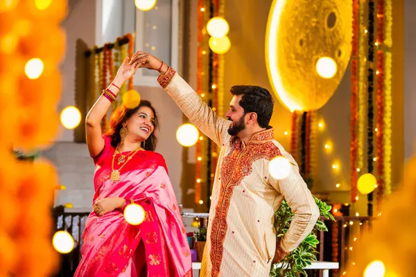 Marigold Çelenkleri ve Bayram Işığı ile süslenmiş, Hint Festivali 'nin diwali bayramını etnik kıyafetlerle kutlayan çift.