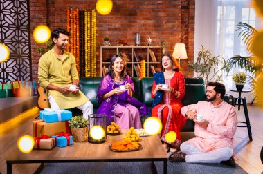 Arkadaşlar Diwali 'yi çay, Hint Asyalı aile ve geleneksel şenlik kıyafetleriyle kutluyorlar. Hint festivali Deepavali' nin tadını çıkarıyorlar. Süslü evde çay ya da kahveyi klasik bir çömlekle yudumluyorlar.