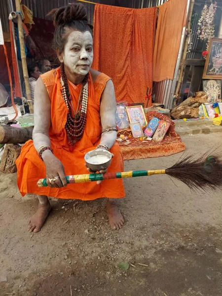 Calcutta, West Bengal,India 8th January 2023:Sadhavi or women sadhu smeared with vibhuty or holy ash waiting for devotees to bless at Gangasagar transit camp or akhara .