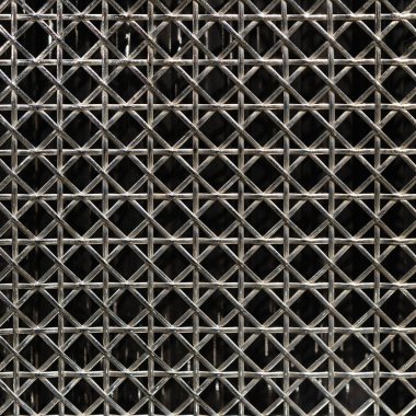 A closeup of a metal grid pattern featuring intricate crossed lines on a dark background for industrial design clipart