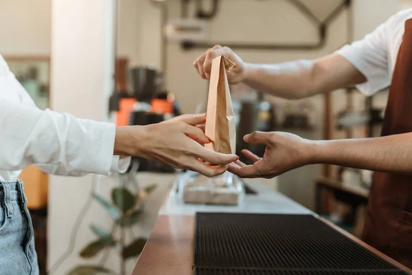 stock image Waitress giving paper bag to customer at coffee shop. SME business coffee shop concept.