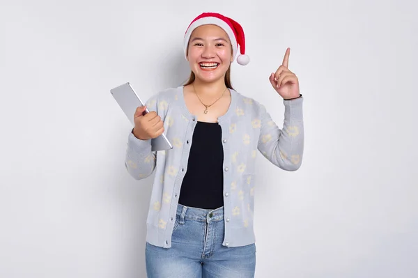 Smiling Young Asian Woman Hat Christmas Holding Digital Tablet Pointing Royalty Free Stock Photos