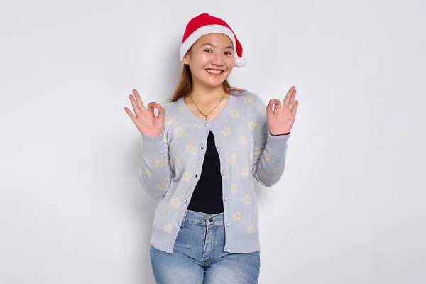 Portrait Smiling Young Asian Woman Santa Claus Hat Showing Okay Royalty Free Stock Images