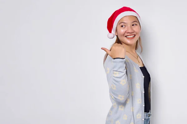 Smiling Young Asian Woman Santa Claus Hat Pointing Thumb Copy Royalty Free Stock Images