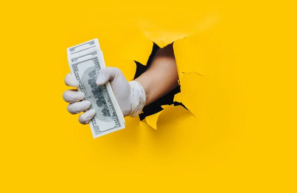 Man Holds Money White Medical Gloves Isolated Yellow Torn Hole Royalty Free Stock Photos