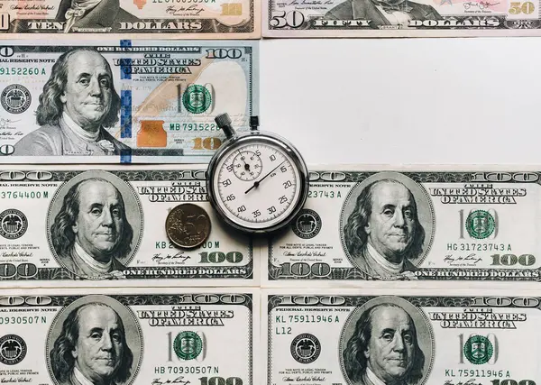 Stopwatch and dollars. Time is money concept. Banknotes and coins. Money loan. Credit debt. Copy space.