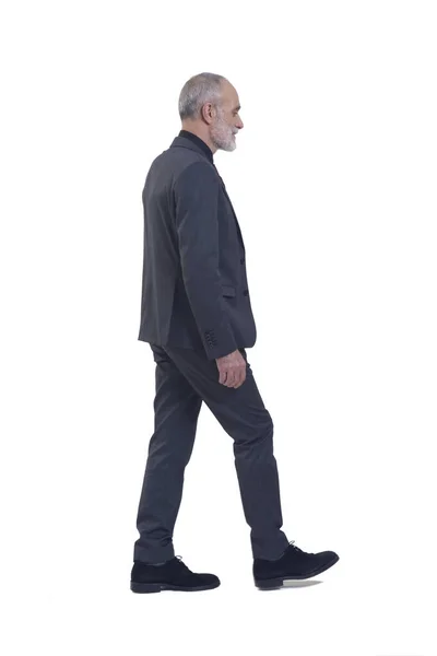 stock image side and back view of a man with suit and tie walking on white background