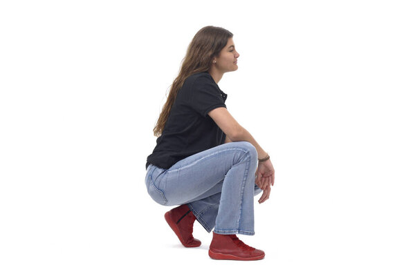 side view of a young girl long-haired sitting squatting on white background