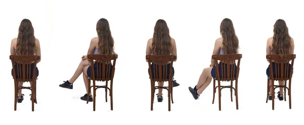 一群坐在白色背景椅子上的年轻姑娘的背影 — 图库照片