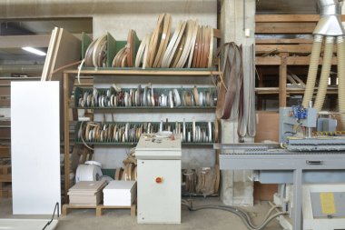 Bir marangozhanede formika kenarları düzleştiriyor