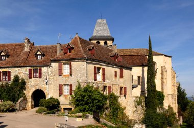 gateway  and church of St John the Baptist, Loubressac, Lot, France clipart