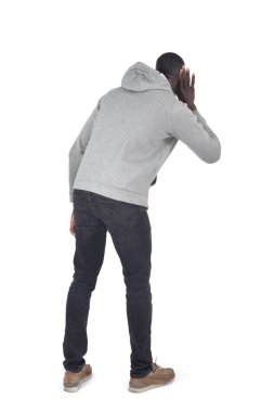 Kulağı kulağında beyaz arka planda dinleyen bir adam.