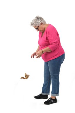 older woman throwing a paper on the ground on white background clipart