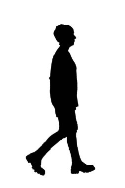 silhouette of side view of a full length portrait of woman walking  in tight jean pants 