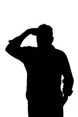 silhouette of a man hand on forehead looking far