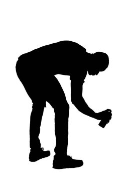silhouette of  side view of a crouching man painting with a spray on white background