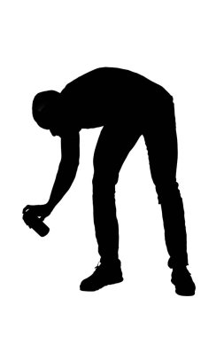 silhouette of   side view of a crouching man painting with a spray