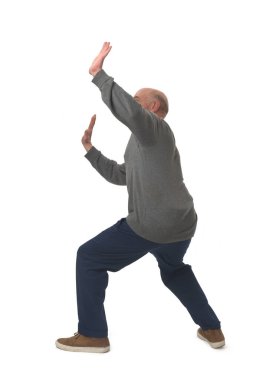 side view of a man standing holding or pushing up something imaginary 