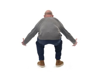 back view of a man lifting something heavy from the ground on white background