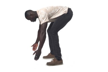 side view of a man lifting something imaginary, large or heavy from the ground on white background