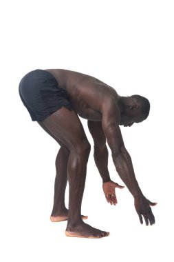 side view of a man wearing shorts lifting something imaginary, large or heavy from the ground on a white background.