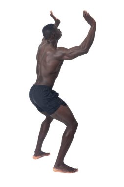 back side view of a man wearing shorts pushing something imaginary upwards