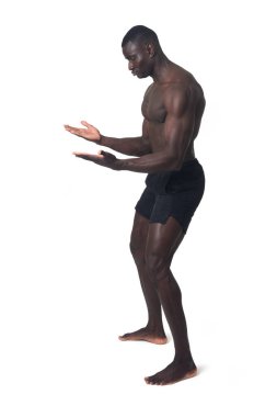 side view of a man holding or lifting something imaginary at waist level on a white background