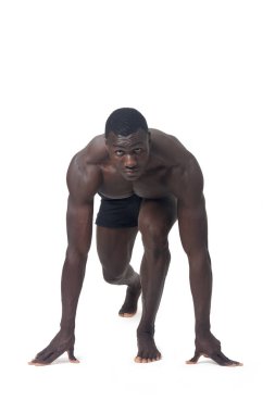 Front view of a man wearing shorts in starting position for a race.