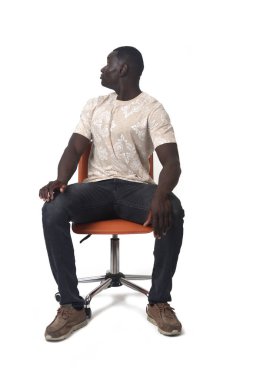 Man sitting on a chair looking back on white background