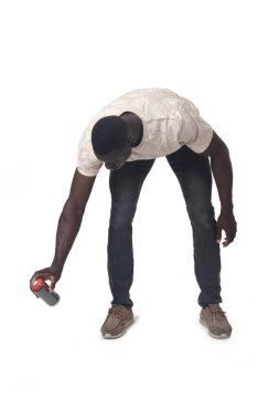 front view of a crouching man painting with a spray