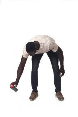 front view of a crouching man painting with a spray