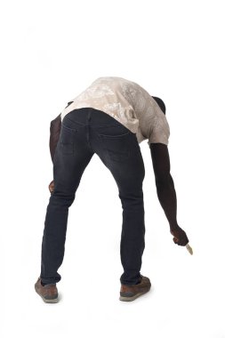 back view of a crouching man painting the ground imaginarily