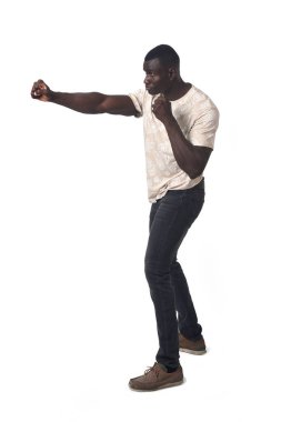 side view of standing man showing a punch on white background