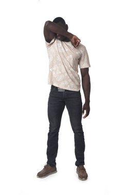 front view of a man covering his face with his elbow on white background