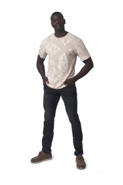 front view of a man standing with his hands in his pockets on white background