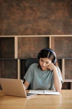 Bilgisayarlı akıllı Asyalı kadın evde bilgisayar öğreniyor. Yüksek kalite fotoğraf