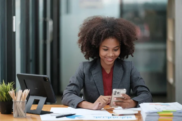 American African Woman working in the office with computer phone and Tablet. High quality photo