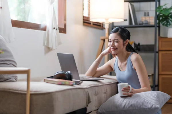 stock image Young asian woman working on computer laptop at house. Work at home, Video conference, Video call, Student learning online class, Shopping online.. High quality photo